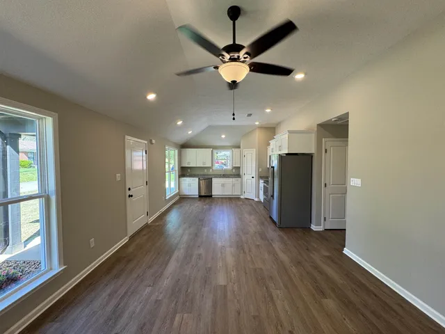 a view of a livingroom with a hardwood floor and a ceiling fan