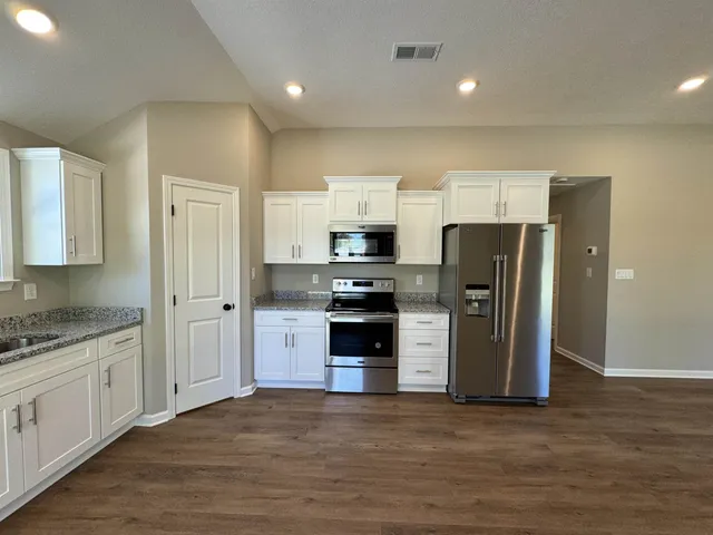 a kitchen with stainless steel appliances a refrigerator stove and sink