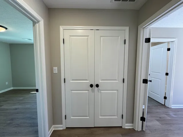 an entryway door with wooden floor