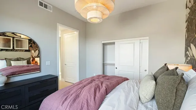 a bedroom with a bed and a mirror