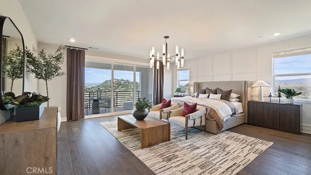 a spacious bedroom with a bed and wooden floor