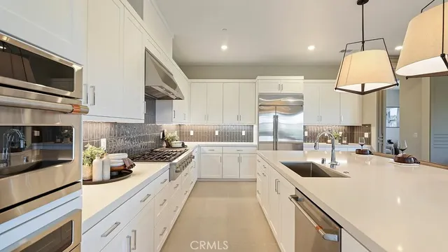a kitchen with stainless steel appliances a stove sink and cabinets