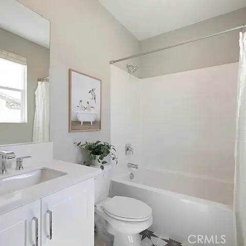 a bathroom with a sink a toilet a mirror a vanity and shower