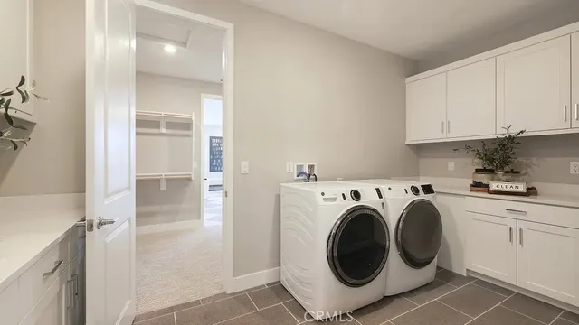 a utility room with sink dryer and washer