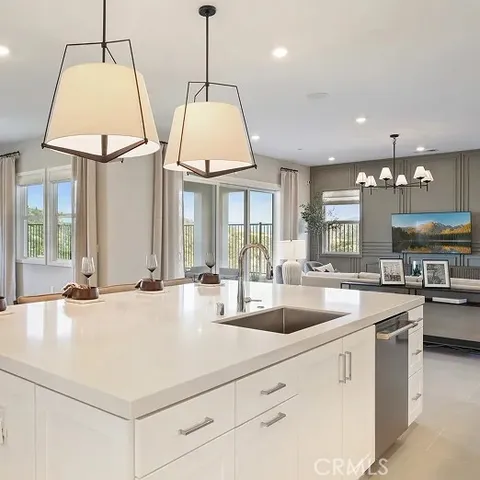 a kitchen with stainless steel appliances granite countertop a sink a stove and a wooden floors