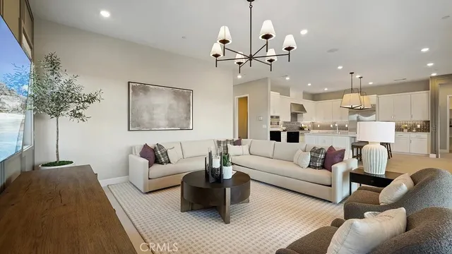 a living room with furniture and a chandelier