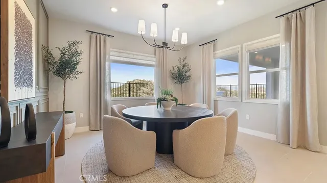 a dining room with furniture a chandelier and wooden floor