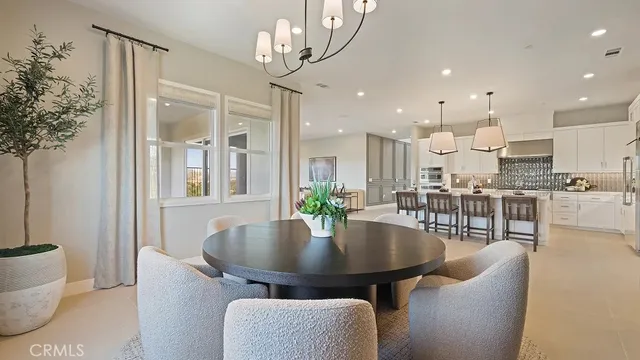 a dining room with furniture and a chandelier