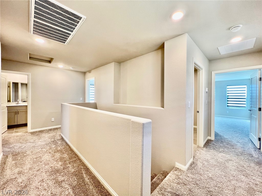 7845 Morganite Avenue Las Vegas, NV 89113 - Photo 13 of 21 A versatile upstairs landing connects various rooms, ideal for flexible living arrangements.