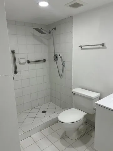 an empty room with sliding door and wooden floor