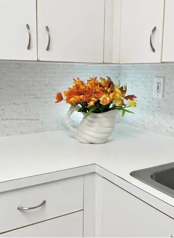 a bathroom with a granite countertop toilet sink and mirror