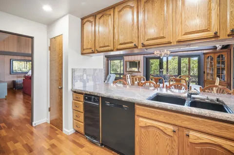 a kitchen with stainless steel appliances granite countertop a sink and cabinets
