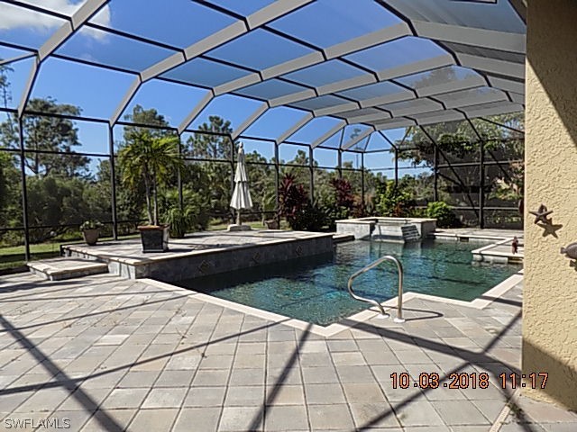 19220 La Serena Drive Estero, FL 33967 - Photo 7 of 27 a view of a patio with a table and chairs under an umbrella