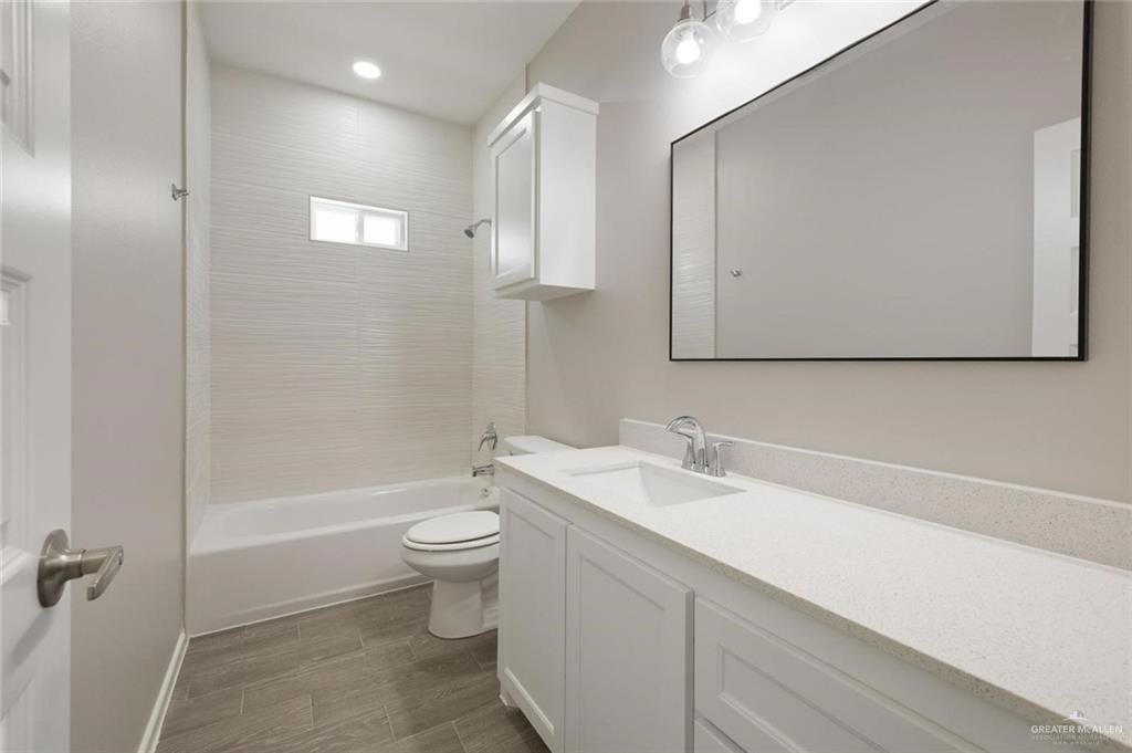 740 North Alamo Road, Unit 18 Alamo, TX 78516 - Photo 16 of 18 a bathroom with a sink a toilet and shower