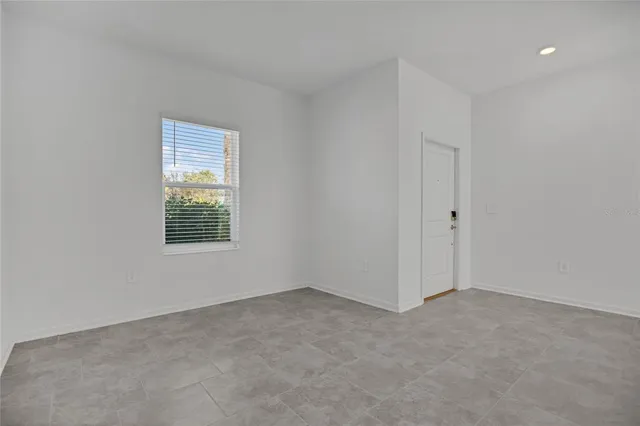 a bathroom with a granite countertop bathtub shower sink vanity mirror and toilet