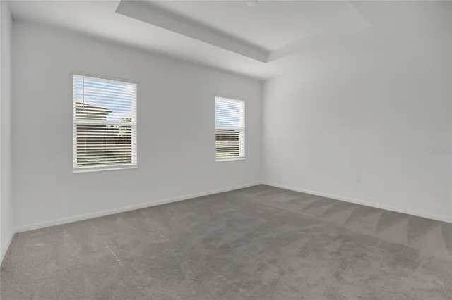 a en suite bathroom with 2 sink flowerpot and a mirror