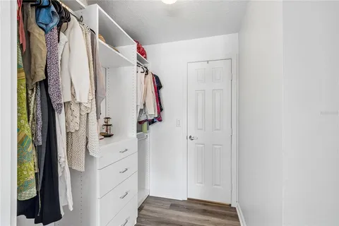 a view of walk in closet with clothes