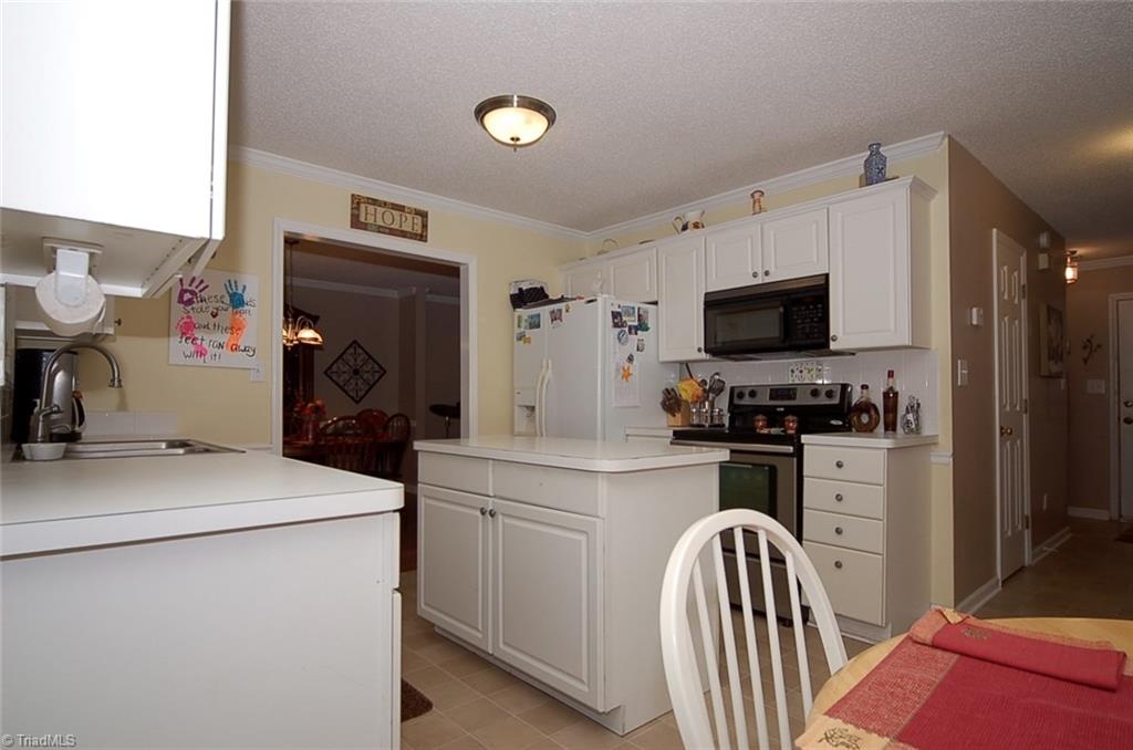 3338 Timberwolf Avenue High Point, NC 27265 - Photo 11 of 30 The kitchen island offers additional storage and work space.