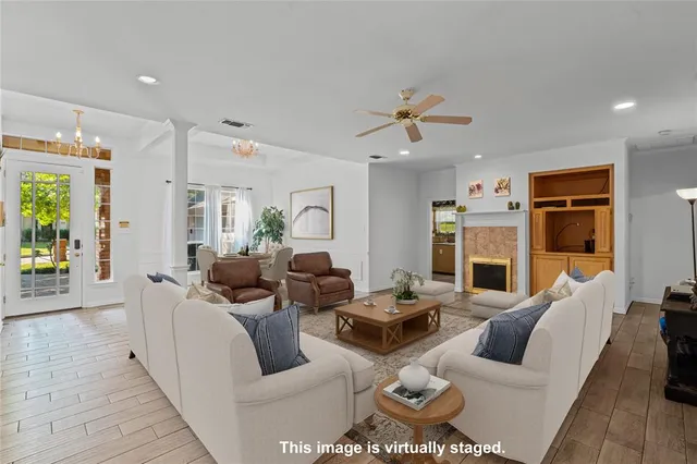 a living room with furniture fireplace and a view of kitchen