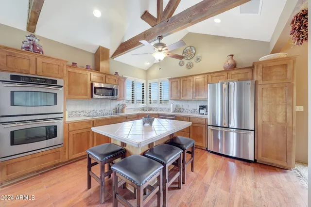 a living room with furniture a chandelier and a large window