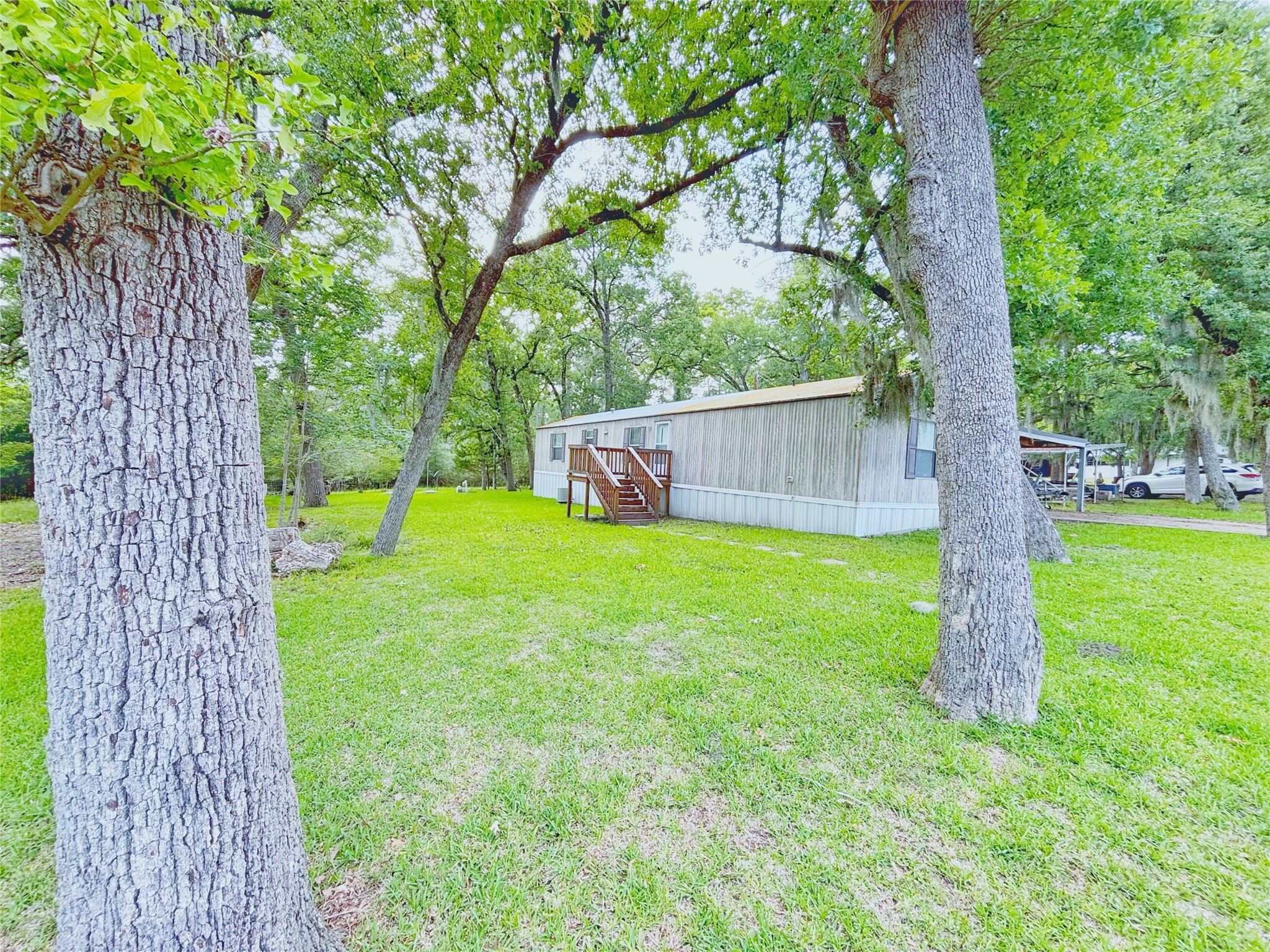 8 River Drive Trinity, TX 75862 - Photo 29 of 36 a view of a backyard with a small cabin and wooden fence