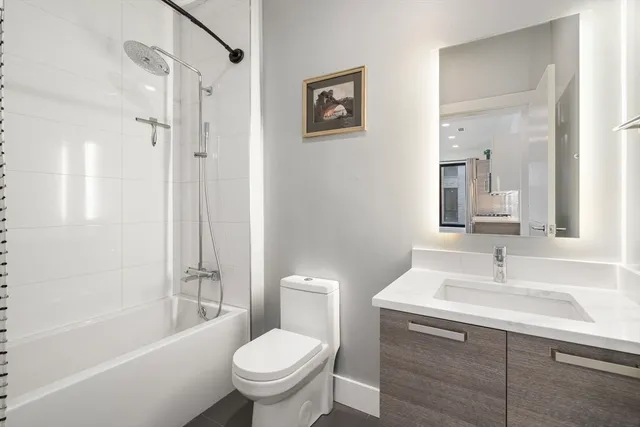 a bathroom with a sink toilet and shower