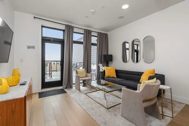 a view of a roof deck with table and chairs