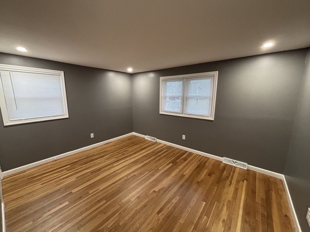 108 Reed Street, Unit R Randolph, MA 02368 - Photo 16 of 21 a view of an empty room with wooden floor and a window