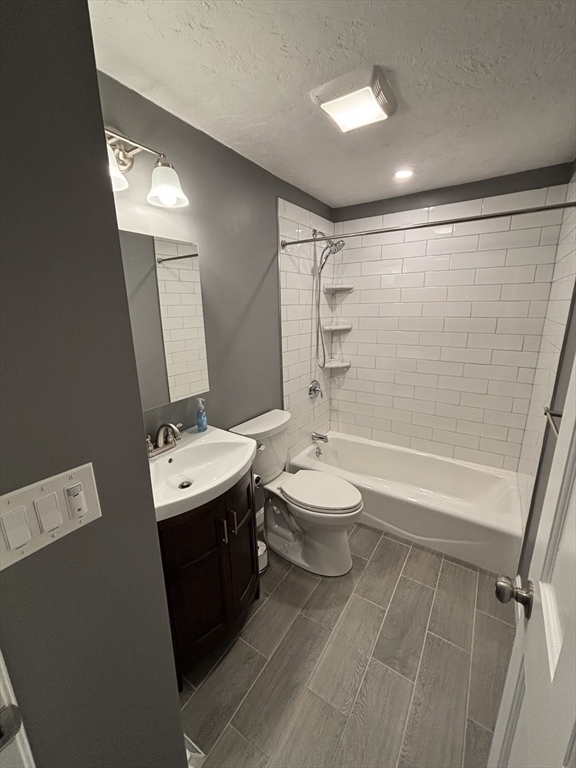 108 Reed Street, Unit R Randolph, MA 02368 - Photo 18 of 21 a bathroom with a toilet sink and mirror