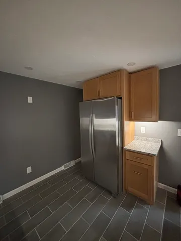 a kitchen with a sink a refrigerator and cabinets
