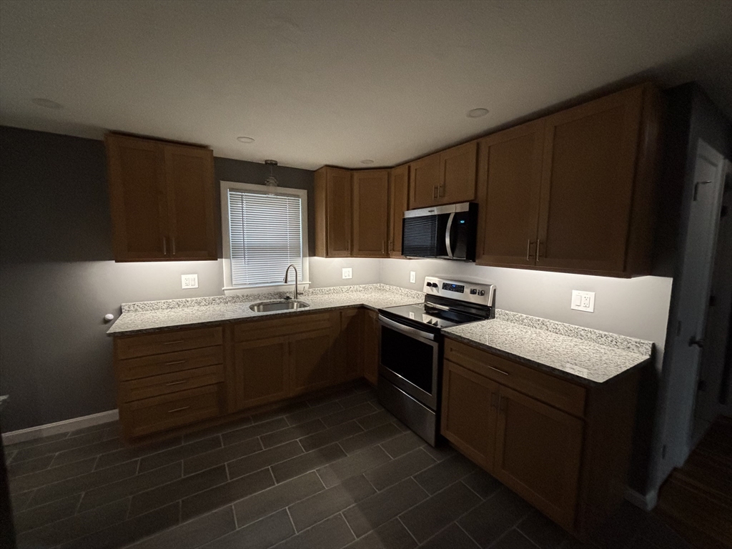 108 Reed Street, Unit R Randolph, MA 02368 - Photo 5 of 21 a kitchen with a sink stove and microwave