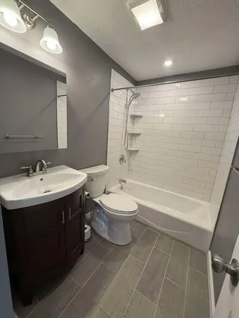 a bathroom with a double vanity sink toilet and shower
