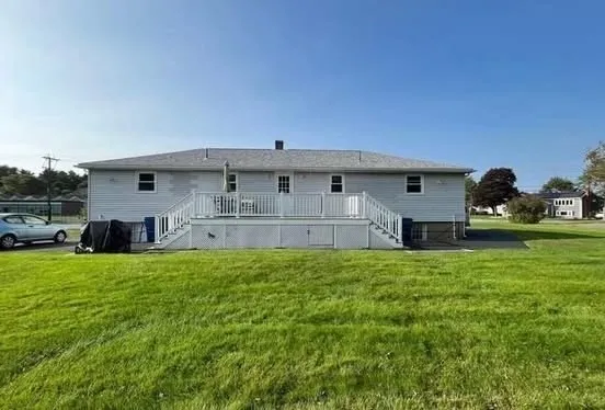 a front view of house with yard and car parked