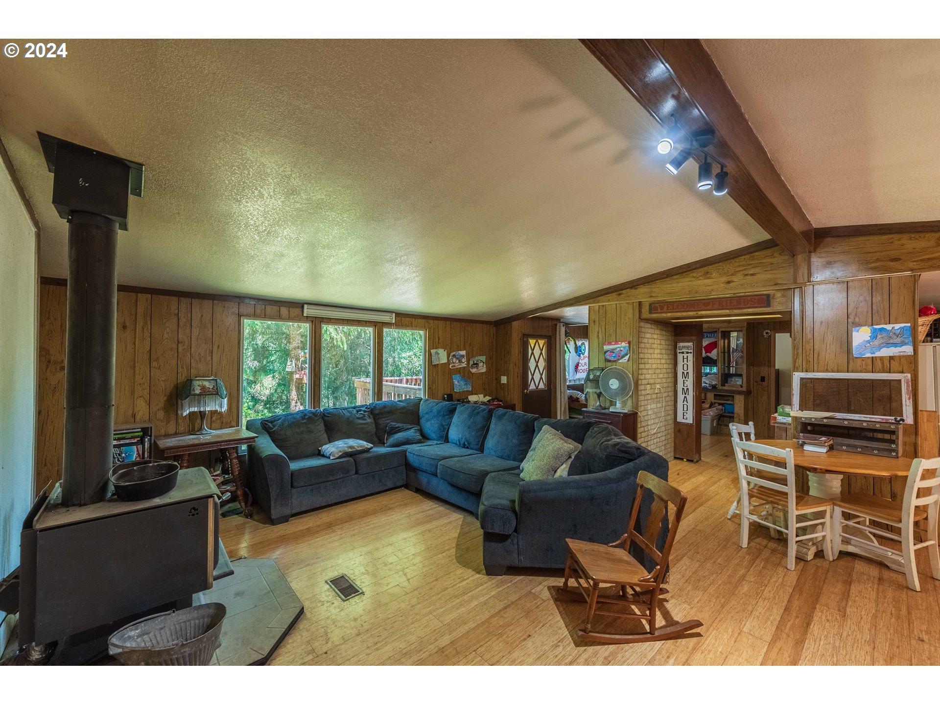 339 Jd Lane Reedsport, OR 97467 - Photo 8 of 35 a living room with furniture a fireplace and a flat screen tv