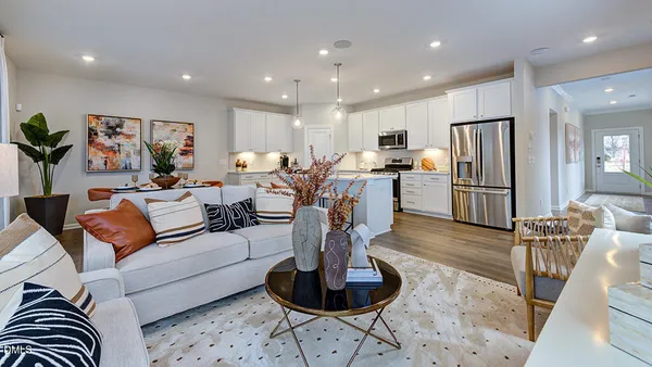 a dining room with furniture a painting and wooden floor