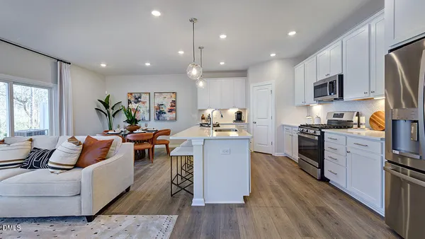 a dining room with furniture and wooden floor
