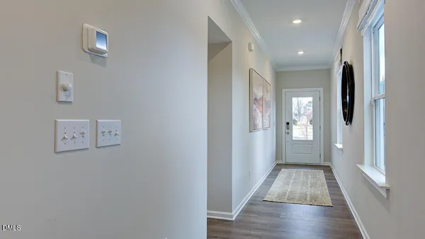 a living room with furniture kitchen and a chandelier