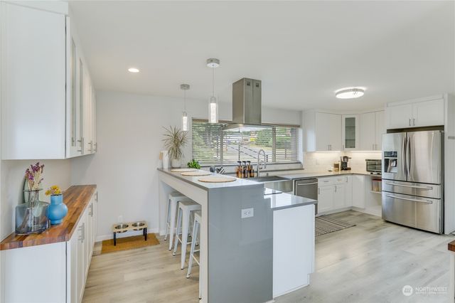a kitchen with a sink stainless steel appliances and cabinets