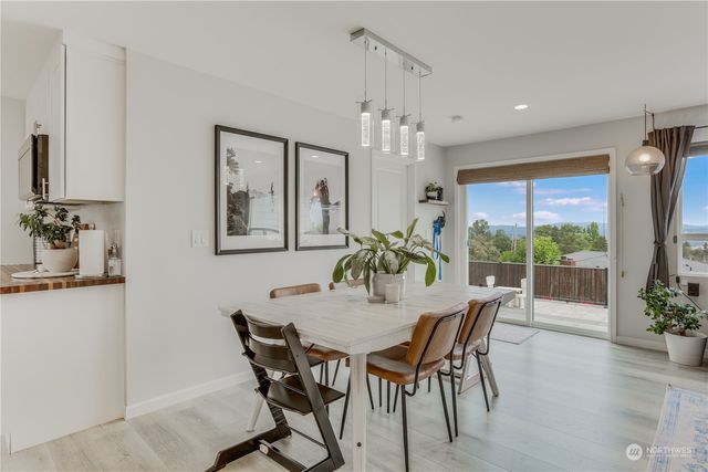 a dining room with furniture a chandelier and wooden floor