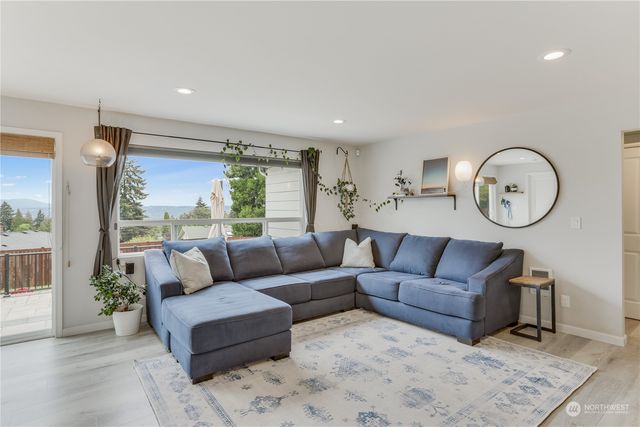 a living room with couch a rug and a large window