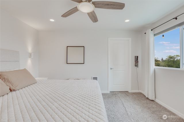 a bedroom with a large bed and a chandelier