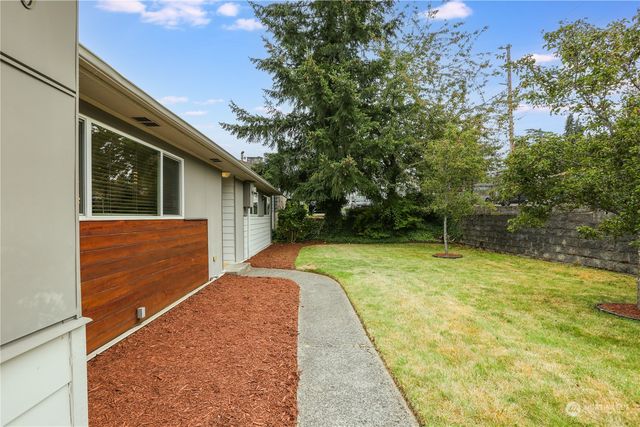 a view of backyard of house with green space