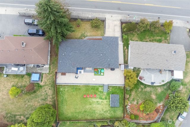 an aerial view of a house with yard swimming pool and outdoor seating