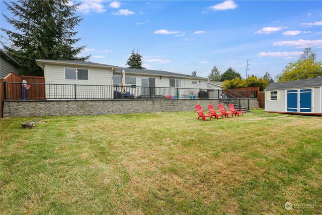 a aerial view of a house with swimming pool garden and patio