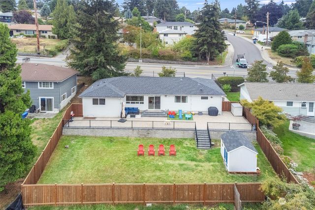 an aerial view of residential houses with outdoor space and street view