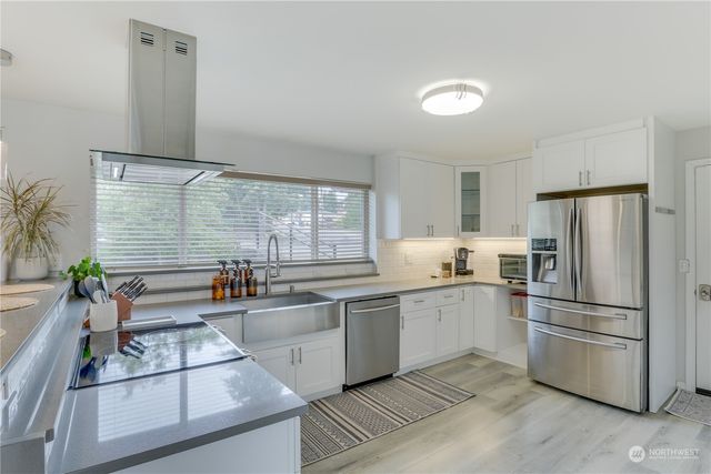 a kitchen with granite countertop a refrigerator and a sink