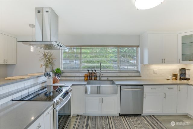 a kitchen that has a sink and a stove