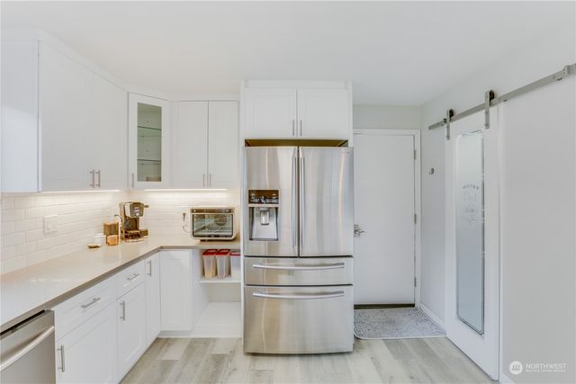 a kitchen with stainless steel appliances a refrigerator and cabinets