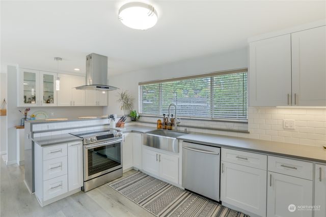 a kitchen with a sink stove and cabinets