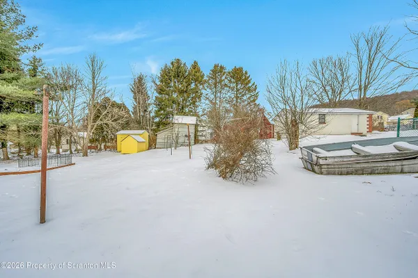 a view of a house with a yard and sitting area